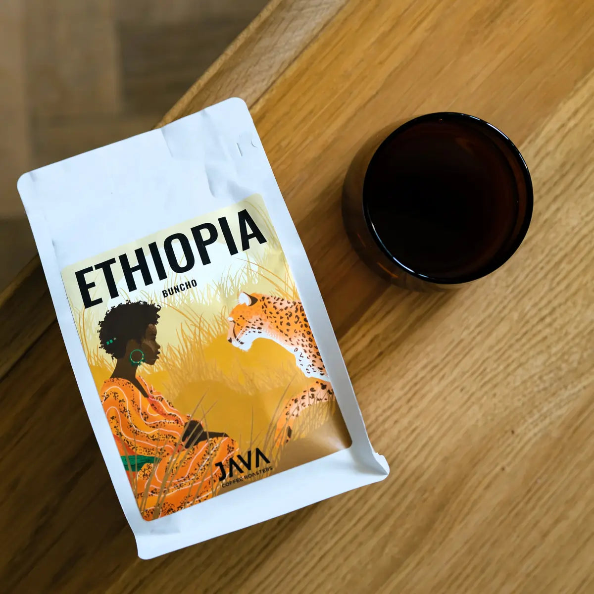 JAVA Coffee Ethiopia Buncho – świeżo palona kawa specialty obok filiżanki z kawą na drewnianym stole, widok z góry