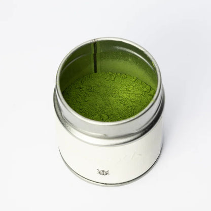Oromatcha Premium Matcha – otwarta puszka z proszkiem matcha, packshot na białym tle