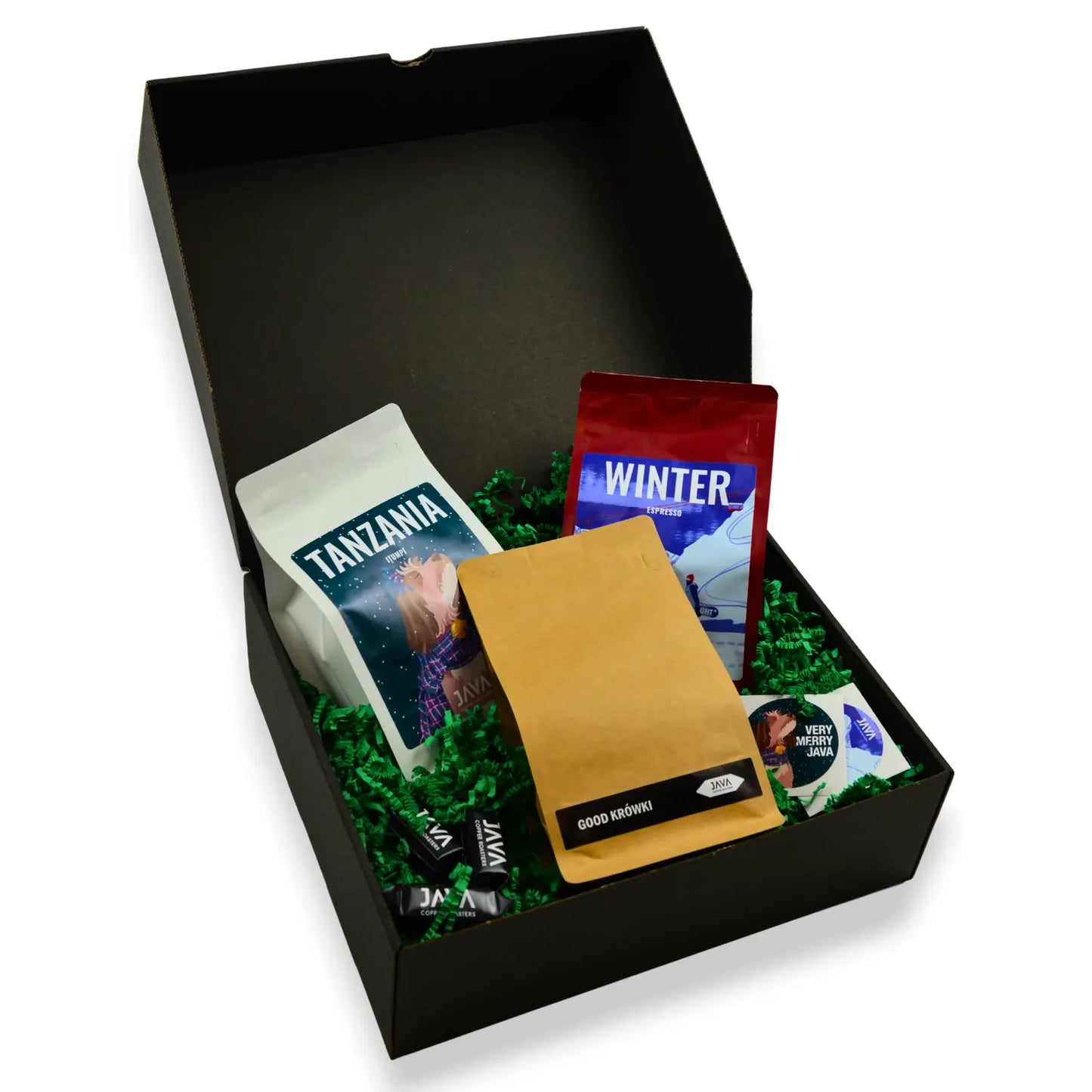 Świąteczny zestaw prezentowy JAVA Coffee z kawami Tanzania Itumpi i Winter Espresso, kraftową paczką oraz krówkami w czarnym pudełku z zielonym wypełniaczem.